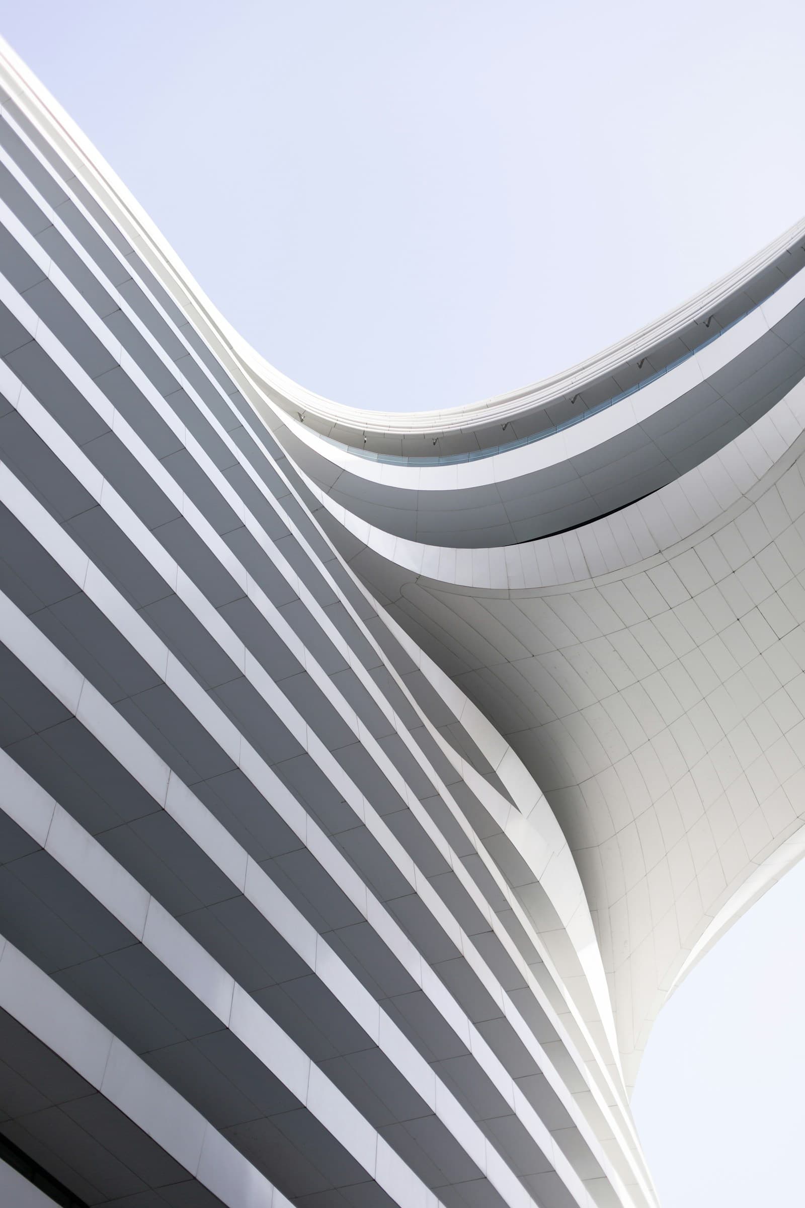 Curved facade against open sky — production build in motion